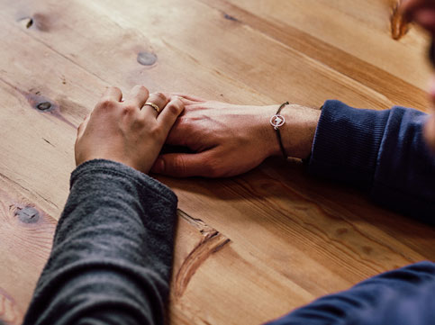 two hands holding in support of a friends cancer two hands holding in support of a friends cancer