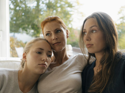 two daughters hugging their mother. image for family cancer support & family cancer two daughters hugging their mother. image for family cancer support & family cancer