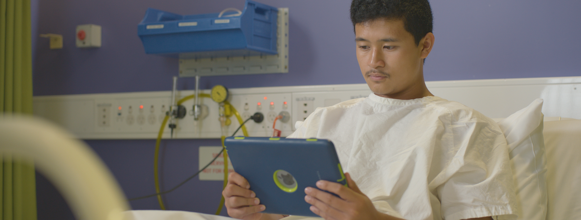 cancer patient using the Canteen robots service on an ipad. service that is help for cancer patients